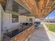 This outdoor kitchen showcases a built-in grill, bar counter, custom ceiling, and spacious covered patio at 6235 Westwind Rd, Las Vegas, NV 89118