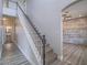Open staircase with carpet steps, featuring a view into living area with paneled wall at 6235 Westwind Rd, Las Vegas, NV 89118
