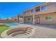Rear view of the home showing the patio, pool, raised hot tub and upper level balcony at 7380 Abundant Harvest Ave, Las Vegas, NV 89131