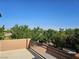 Balcony overlooking mature trees, landscaped grounds, and a walking path at 7380 Abundant Harvest Ave, Las Vegas, NV 89131