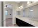 Bathroom featuring double sinks, a large mirror, and a shower/tub combo at 7380 Abundant Harvest Ave, Las Vegas, NV 89131