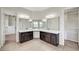 Primary bathroom with dual vanities and large mirrors, plus walk-in closet access at 7380 Abundant Harvest Ave, Las Vegas, NV 89131