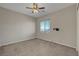 Bedroom featuring a ceiling fan, a window, and carpeted flooring at 7380 Abundant Harvest Ave, Las Vegas, NV 89131