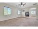 Spacious bedroom featuring a fireplace, ceiling fan, and large windows for natural light at 7380 Abundant Harvest Ave, Las Vegas, NV 89131
