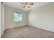 Cozy bedroom with a ceiling fan and a window, showcasing a comfortable living space at 7380 Abundant Harvest Ave, Las Vegas, NV 89131