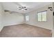 Bedroom with ceiling fan, neutral paint, and large windows providing ample natural light at 7380 Abundant Harvest Ave, Las Vegas, NV 89131