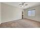 Bedroom with carpet, neutral walls, ceiling fan and window at 7380 Abundant Harvest Ave, Las Vegas, NV 89131