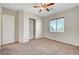 Standard bedroom with standard closet, ceiling fan and a sunlit window at 7380 Abundant Harvest Ave, Las Vegas, NV 89131