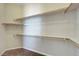 Walk-in closet featuring built-in shelving and carpeted flooring at 7380 Abundant Harvest Ave, Las Vegas, NV 89131