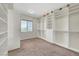 Spacious walk-in closet with custom built-in shelving, ample storage, and natural light from the window at 7380 Abundant Harvest Ave, Las Vegas, NV 89131