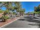 Gated entrance to the community with decorative metal gates and stone pillars at 7380 Abundant Harvest Ave, Las Vegas, NV 89131