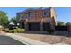 Two story home with a two car garage, landscaped yard, and brick driveway at 7380 Abundant Harvest Ave, Las Vegas, NV 89131