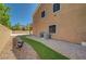 Side view of the home showcasing the gravel yard with turf accents that lead to the backyard at 7380 Abundant Harvest Ave, Las Vegas, NV 89131