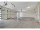 Spacious three car garage featuring sealed concrete floors and overhead storage at 7380 Abundant Harvest Ave, Las Vegas, NV 89131