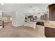 Open concept kitchen featuring an island, stainless steel appliances, dark cabinetry, and modern countertops at 7380 Abundant Harvest Ave, Las Vegas, NV 89131
