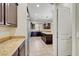 Spacious kitchen showcases granite countertops, stainless steel appliances, and dark wood cabinetry at 7380 Abundant Harvest Ave, Las Vegas, NV 89131