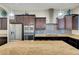 Modern kitchen featuring a large island, stainless steel appliances, and stylish backsplash at 7380 Abundant Harvest Ave, Las Vegas, NV 89131