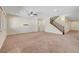 Open-concept living space with adjacent staircase and multiple doorways for easy home access at 7380 Abundant Harvest Ave, Las Vegas, NV 89131