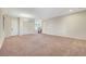 Spacious living room featuring neutral carpet, chandelier lighting and adjacent entry and stairway at 7380 Abundant Harvest Ave, Las Vegas, NV 89131