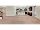 Open-concept space blends the living room and kitchen with a view of stainless steel appliances and a breakfast bar at 7380 Abundant Harvest Ave, Las Vegas, NV 89131