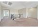 Spacious loft area with carpet, decorative railing, and a bright, airy feel at 7380 Abundant Harvest Ave, Las Vegas, NV 89131