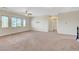Spacious loft with a ceiling fan, neutral carpeting, and bright natural light at 7380 Abundant Harvest Ave, Las Vegas, NV 89131