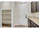 Pantry with white shelving and granite countertops at 7380 Abundant Harvest Ave, Las Vegas, NV 89131