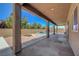 Covered patio with view of the backyard oasis, perfect for outdoor entertaining and relaxation at 7380 Abundant Harvest Ave, Las Vegas, NV 89131