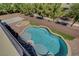 An elevated view of the crystal-clear swimming pool, artificial turf, and surrounding brickwork at 7380 Abundant Harvest Ave, Las Vegas, NV 89131