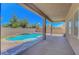 Inviting backyard pool with mature landscaping, patio, and privacy fence provides a relaxing outdoor retreat at 7380 Abundant Harvest Ave, Las Vegas, NV 89131