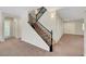 Elegant staircase with wrought iron railing leading to the upper level of the home at 7380 Abundant Harvest Ave, Las Vegas, NV 89131