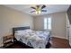 Comfortable bedroom with hardwood floors, ceiling fan, and ample natural light from shuttered window at 7520 Fontera Ct, Las Vegas, NV 89139