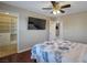 This bedroom features a ceiling fan, a mounted TV, and an ensuite closet, providing both comfort and convenience at 7520 Fontera Ct, Las Vegas, NV 89139