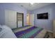 Comfortable bedroom featuring plush carpet, closet space, a TV, and serene ambiance at 7520 Fontera Ct, Las Vegas, NV 89139