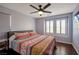 This bedroom features natural light from the window and a modern ceiling fan for a comfortable space at 7520 Fontera Ct, Las Vegas, NV 89139