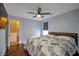 Bedroom boasting a ceiling fan, window, and an adjacent walk-in closet for convenience and comfort at 7520 Fontera Ct, Las Vegas, NV 89139