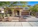 Inviting two-story home with a covered porch, a two car garage, and xeriscaped front yard at 7520 Fontera Ct, Las Vegas, NV 89139