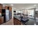 Gourmet kitchen with dark countertops, stainless appliances, lots of wood cabinetry, and open floor plan at 7520 Fontera Ct, Las Vegas, NV 89139