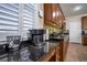 Kitchen featuring dark granite counters, wood cabinets, stainless appliances, and ample counter space at 7520 Fontera Ct, Las Vegas, NV 89139