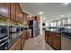 Well-appointed kitchen featuring dark granite counters, stainless steel appliances, and lots of cabinets at 7520 Fontera Ct, Las Vegas, NV 89139