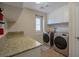 Well-equipped laundry room with ample counter space, modern washer/dryer, and storage cabinets at 7520 Fontera Ct, Las Vegas, NV 89139