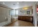 Bright main bathroom with a glass shower, soaking tub, double vanity, and plantation shutters at 7520 Fontera Ct, Las Vegas, NV 89139