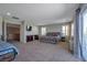Large main bedroom boasts a sitting area, desk, TV, and sliding glass doors to outdoor balcony at 7520 Fontera Ct, Las Vegas, NV 89139