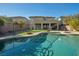 Backyard featuring a pool and spa, complemented by lush landscaping and privacy fencing at 7520 Fontera Ct, Las Vegas, NV 89139