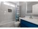 Beautifully updated bathroom with a tiled shower and a vanity with a blue cabinet at 7728 Barbican Ct, Las Vegas, NV 89147
