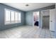 A well-lit bedroom features tiled floors, a large window with shutters, and access to an ensuite bathroom at 7728 Barbican Ct, Las Vegas, NV 89147