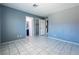 Neutral bedroom with tile flooring, ample natural light, and doorways leading to the bathroom and closet at 7728 Barbican Ct, Las Vegas, NV 89147