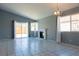 Bright and spacious living room with tile flooring, a fireplace, and sliding glass doors leading to the backyard at 7728 Barbican Ct, Las Vegas, NV 89147