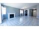 Comfortable living room featuring tile flooring, a brick fireplace, and views into the kitchen and entryway at 7728 Barbican Ct, Las Vegas, NV 89147