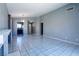 Open living room with tile floors, a fireplace, and views into the kitchen and hallway for easy flow at 7728 Barbican Ct, Las Vegas, NV 89147